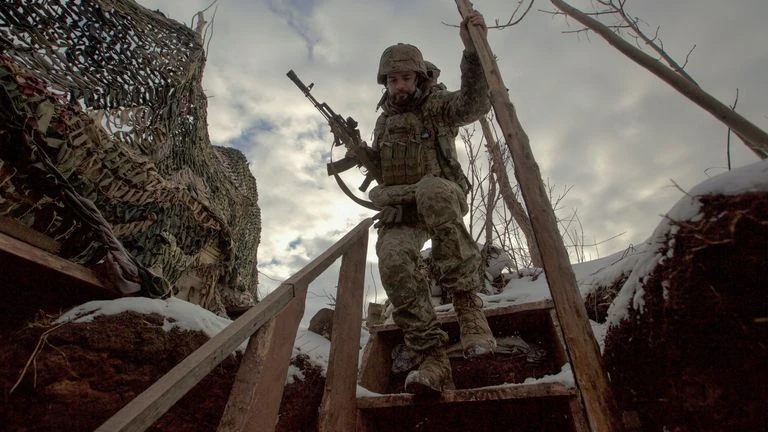 A member of the Ukrainian armed forces patrols the separation line of the Russian-backed rebels near Horlivka in the Donetsk region