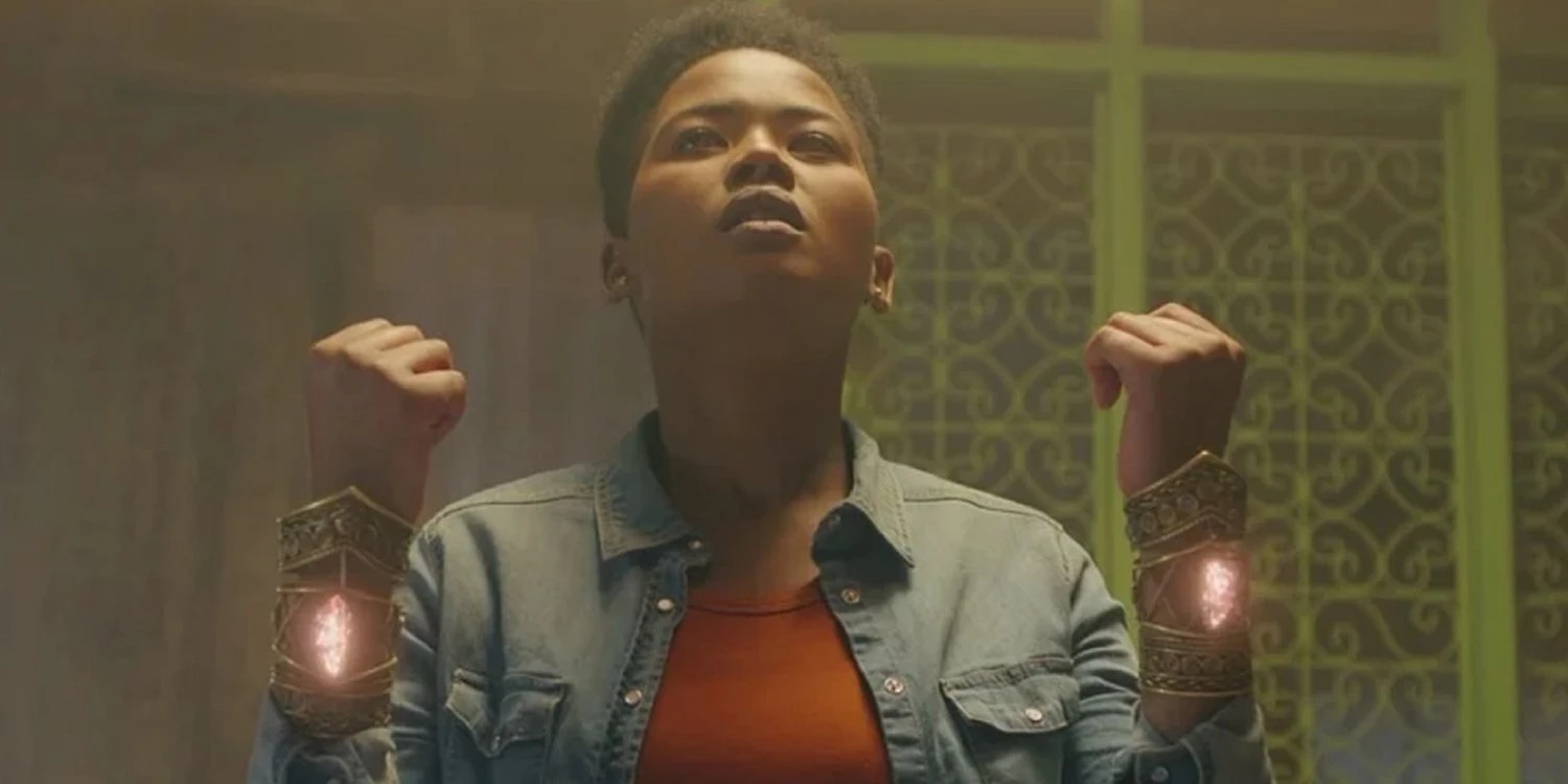 The character, Ntsiki, wearing magic gauntlets in 